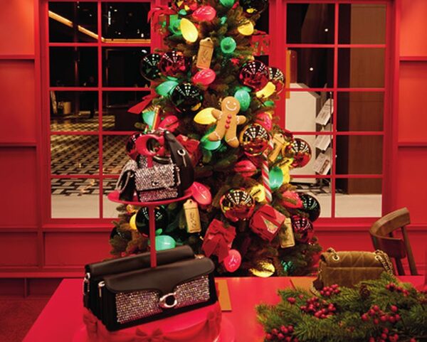 A Coach Christmas tree hung with bags and charms