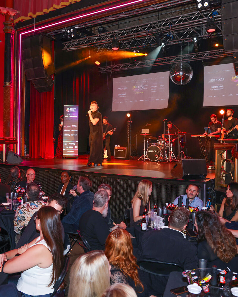 Host Aidan Sadler and the band on stage at The Clapham Grand
